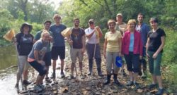 Photo of a group of watershed volunteers next to a stream.